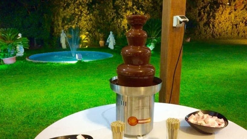 fontana di cioccolata su tavolino con marshmallow